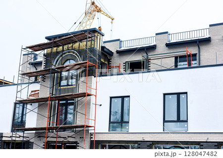 Construction of a new modern building in winter 128047482