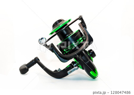 Green fishing reel with fishing line isolated on white background, ideal for outdoor activities and sports 128047486