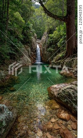A stunning waterfall cascades into a tranquil emerald pool, creating a refreshing oasis amidst the lush greenery, capturing a moment of pure relaxation in the heart of nature 128048395