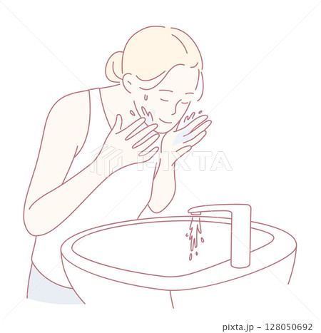 A Person Engaging in the Ritual of Washing their Face at the Sink for an Effective Skincare Routine 128050692