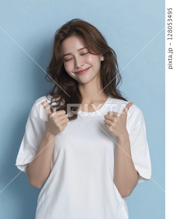 Woman with brown hair is smiling and giving a thumbs up 128053495