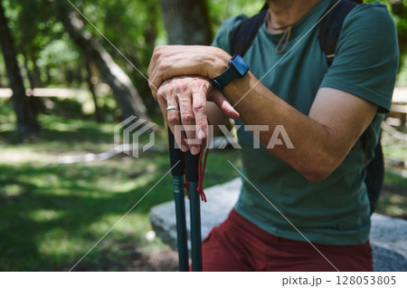 Close-Up of Traveler's Hands Holding Hiking Poles During Outdoor Adventure 128053805