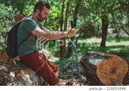 Bearded Hiker Relaxing on a Sunny Summer Day in Lush Forest 128053846