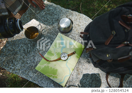 Exploration Essentials on Granite Surface Featuring Map, Compass, and Hiking Gear Exploration Essentials on Granite Surface Featuring Map, Compass, and Hiking Gear 128054524