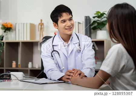 Healthcare Consultation. Doctor providing compassionate care to patient in a medical office. Healthcare Consultation. Doctor providing compassionate care to patient in a medical office. 128055307