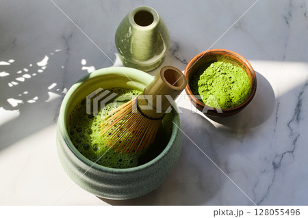 Ceremonial Matcha Setup. Traditional matcha tea set with powder, bamboo whisk Ceremonial Matcha Setup. Traditional matcha tea set with powder, bamboo whisk 128055496