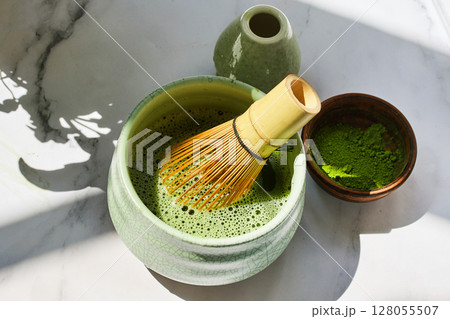 Matcha Tea Preparation. Ceremonial matcha bowl with whisk and matcha powder 128055507