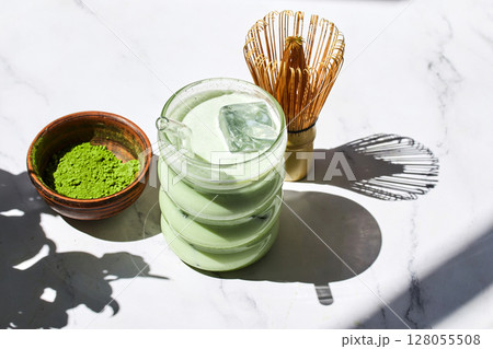 Iced Matcha Refreshment. Refreshing iced matcha drinks with a bamboo whisk and matcha powder 128055508