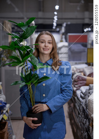 A woman browses a modern store for unique home decor to enhance her living space 128055559