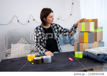 Girl Prepares Packages For Delivery, Running A Small Handmade Business At Home Girl Prepares Packages For Delivery, Running A Small Handmade Business At Home 128056106