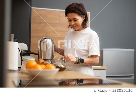 Young Woman Brewing Black Coffee In A Pot In The Kitchen In The Morning Young Woman Brewing Black Coffee In A Pot In The Kitchen In The Morning 128056136