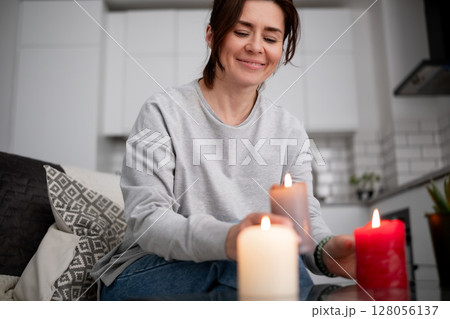 Happy Woman Lighting Aromatic Candles At Home 128056137