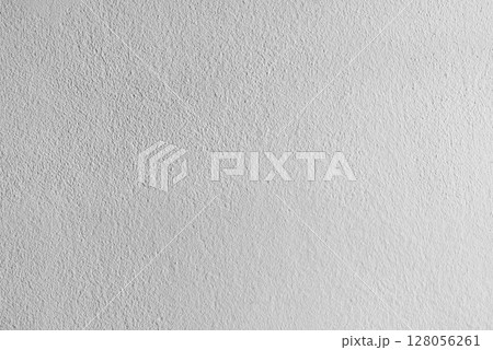 A close-up view of a rough white plaster wall texture, showing its subtle patterns and natural imperfections A close-up view of a rough white plaster wall texture, showing its subtle patterns and natural imperfections 128056261