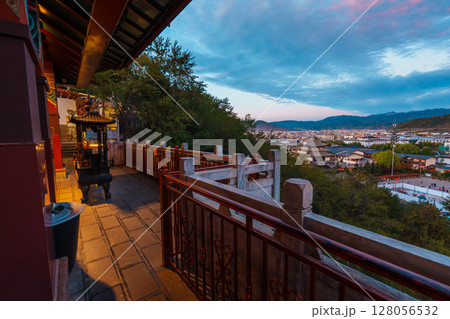 View of Shangri-La's Old Town from a Traditional Balcony at Sunset 128056532