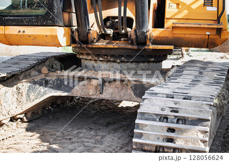 Heavy machinery tracks on a construction site after a day of work in the afternoon sun 128056624