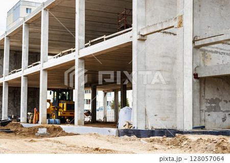 Construction of a reinforced concrete building. Elements of a concrete house. Structural elements. Construction site. Foundations and grillages. Construction of a reinforced concrete building. Elements of a concrete house. Structural elements. Construction site. Foundations and grillages. 128057064