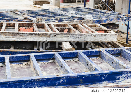 Reinforced concrete foundation of a modern monolithic residential building. Prepared formwork with reinforcing mesh for pouring concrete. Monolithic construction technologies. 128057134