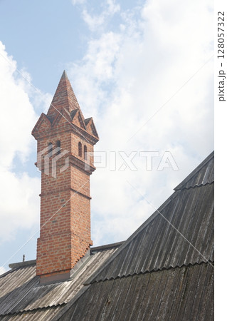House: pitched roofs with brick tiles, visible a chimney 128057322