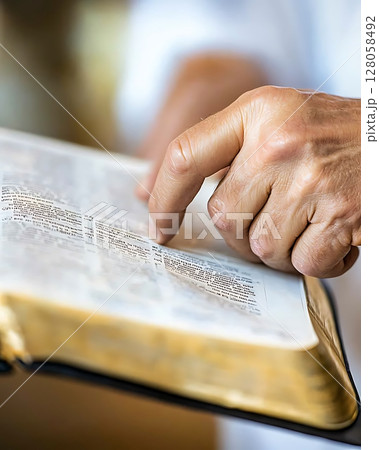 A person is pointing at a page in a book A person is pointing at a page in a book 128058492