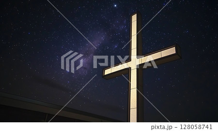 A large cross is lit up against a dark sky 128058741