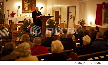 A man stands at a podium in front of a large crowd of people 128058758