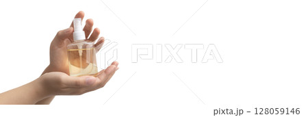 Holding a bottle of hand sanitizer or antiseptic Holding a bottle of hand sanitizer or antiseptic 128059146