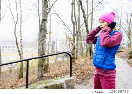 Teenage sporty girl listening to music outdoor. Teenage sporty girl listening to music outdoor. 128060727