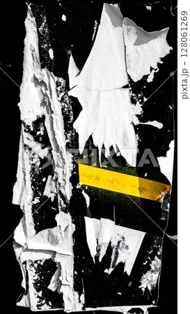 Torn White Poster with Yellow Accent on Black 128061269