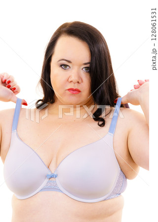 Big woman wearing lingerie holds bra strap Big woman wearing lingerie holds bra strap 128061531