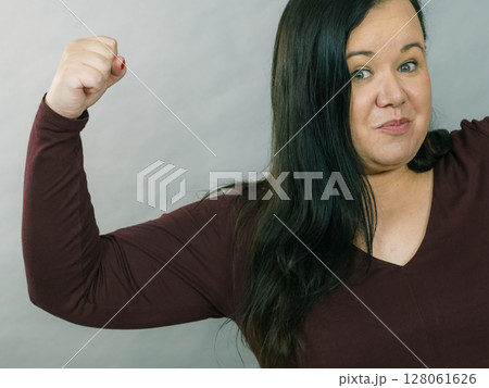 Big woman flexing biceps 128061626