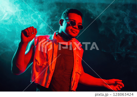 Stylish Man Dressed In Net Dancing In Neon Light, Smoke Studio Or In Night Club 128063424