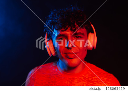 Hipster Man Dressed In Net Dancing In Neon Light In Night Club.music, Headphones 128063429