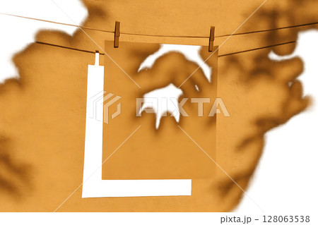 Shadow of a Hanging Poster on Clothesline in Summer Light 128063538