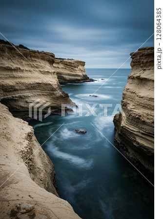 Coastal Cliffs and Ocean Water in Dramatic Light 128064385
