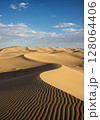 Golden Sand Dunes Under a Blue Sky 128064406