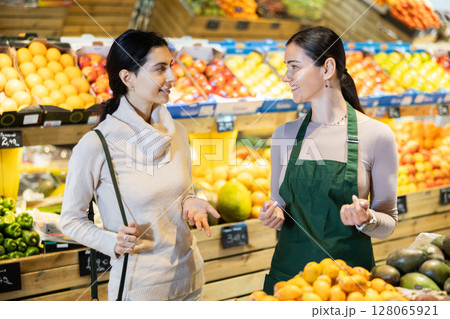saleswoman advises a store client 128065921