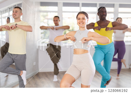 European girl with team of like-minded multinational people learn to elements of electro dance 128066192