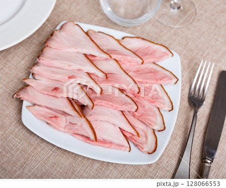 Plate is filled with slices of smoked meat fore shank. Plate is filled with slices of smoked meat fore shank. 128066553
