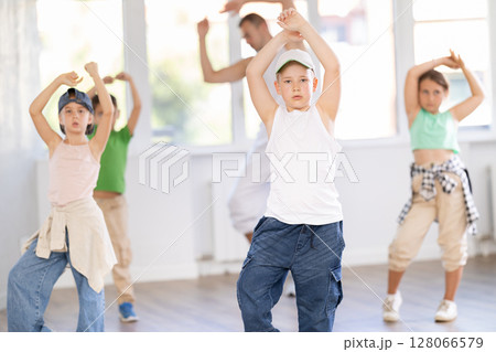 Girls and boys training hip hop in dance studio, dance classes for kids 128066579