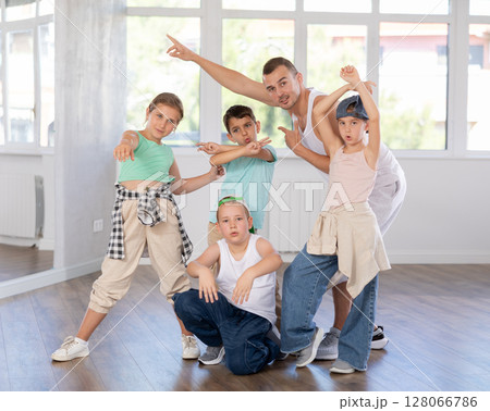 Group of preteen boys and girls hip hop dancers posing in dance studio Group of preteen boys and girls hip hop dancers posing in dance studio 128066786