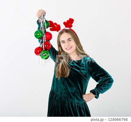 Merry Christmas cute girl reindeer antlers holding Christmas decorations isolated white background Merry Christmas cute girl reindeer antlers holding Christmas decorations isolated white background 128066798