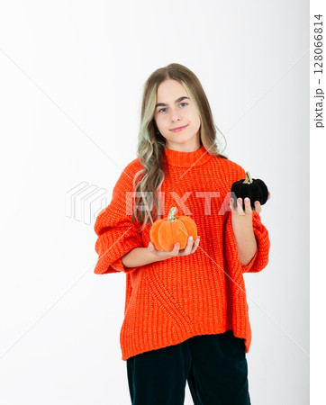 Portrait smiling girl in orange clothes, with pumpkin jack sweet candy. Isolated white background Portrait smiling girl in orange clothes, with pumpkin jack sweet candy. Isolated white background 128066814