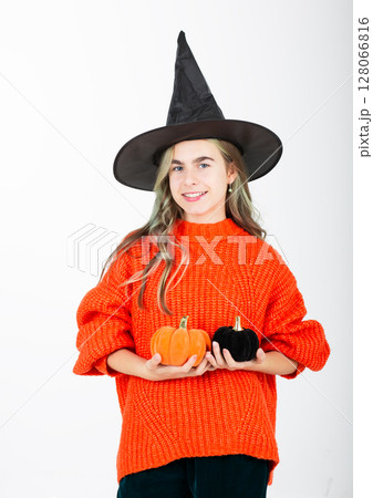 Portrait smiling girl in witch black hat, with pumpkin jack sweet candy. Isolated white background Portrait smiling girl in witch black hat, with pumpkin jack sweet candy. Isolated white background 128066816