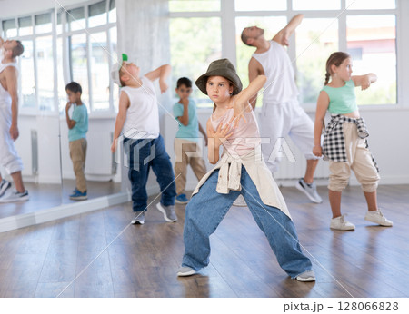 Preteen girl performing hip hop in group class for kids Preteen girl performing hip hop in group class for kids 128066828