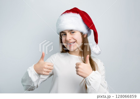 Girl Santa hat showing joy, delight, surprise, approval. Happy emotions, joy Christmas concept. 128066859