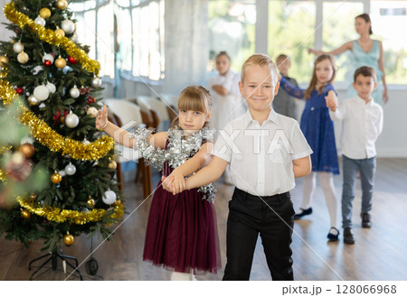 Children rehearsing ballroom dance for upcoming Christmas party at school Children rehearsing ballroom dance for upcoming Christmas party at school 128066968