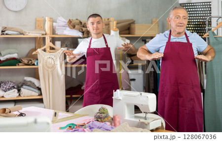 Male tailors doing a warm-up at work 128067036