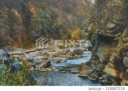 Flow of mountain river among the stone rocks and forest 128067218