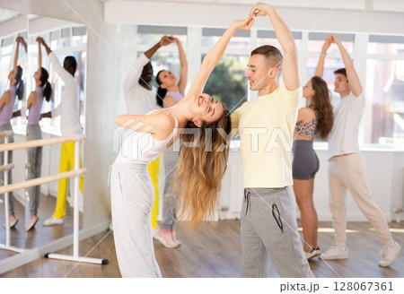 Man and young woman dancing waltz in couple during lesson at studio Man and young woman dancing waltz in couple during lesson at studio 128067361