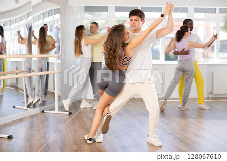 Young man and woman dancing latin dances Young man and woman dancing latin dances 128067610